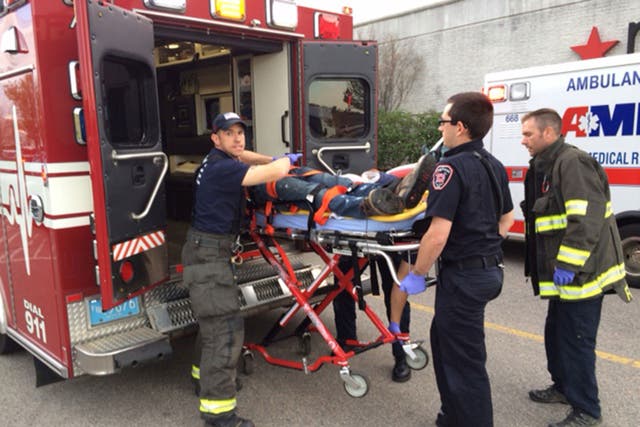 The stabbings suspect is put into an ambulance at Silver City Galleria mall in Taunton, Massachusetts