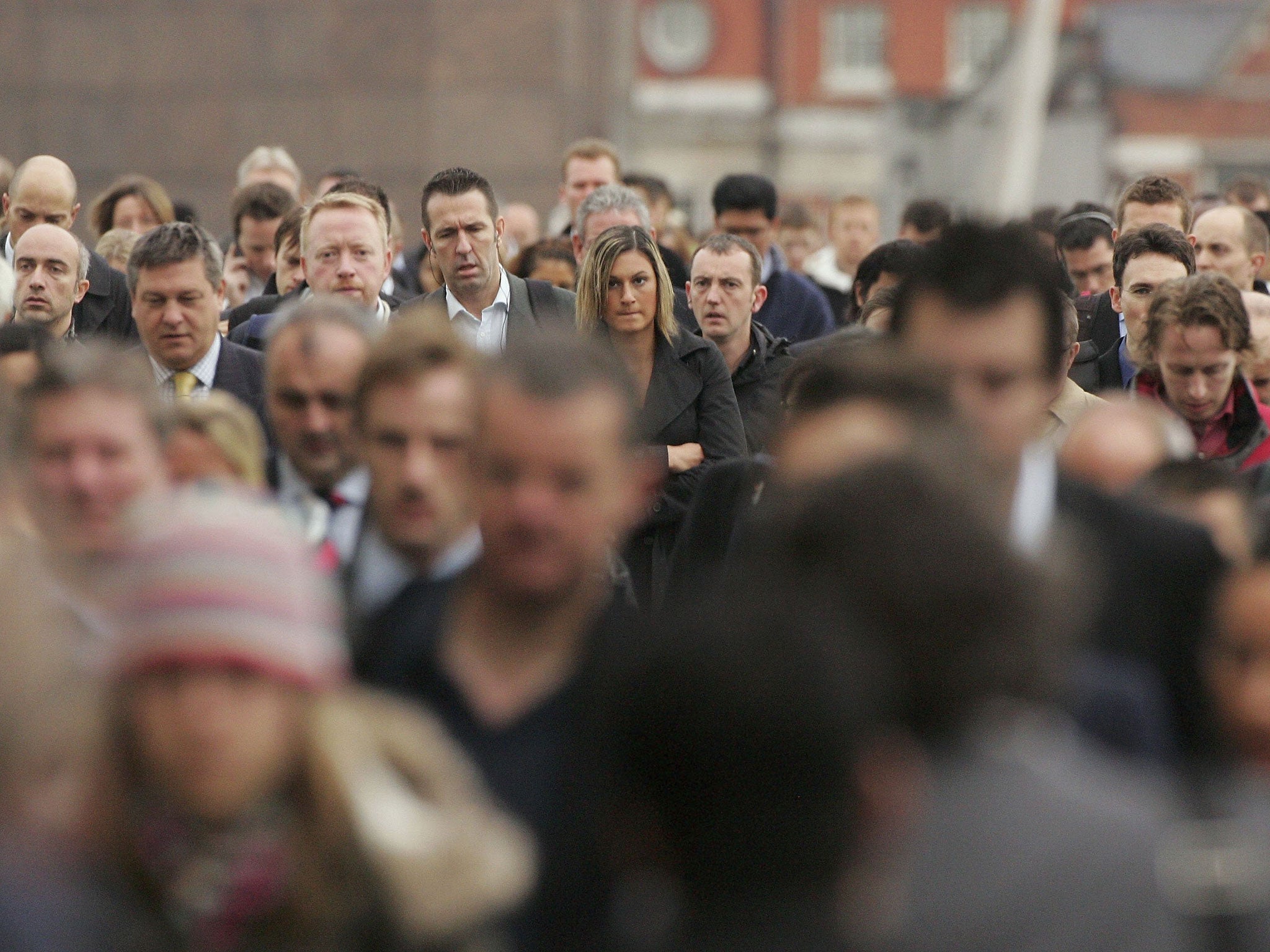 Commuters walk to work over London Bridge