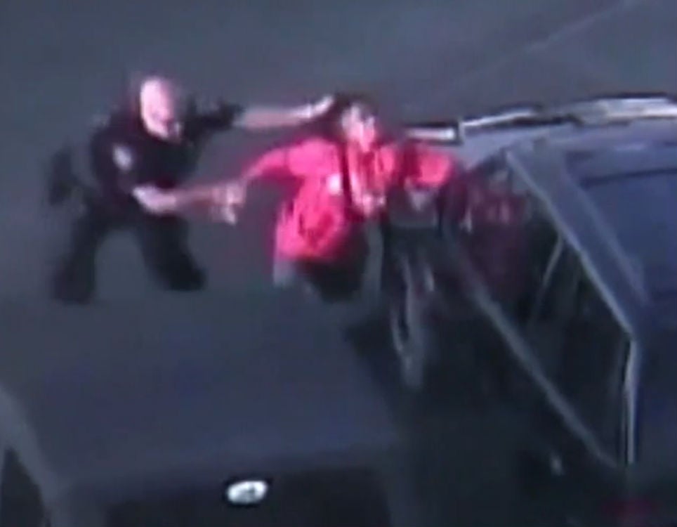 The off-duty officer is seen here yanking the 15-year-old by the hair