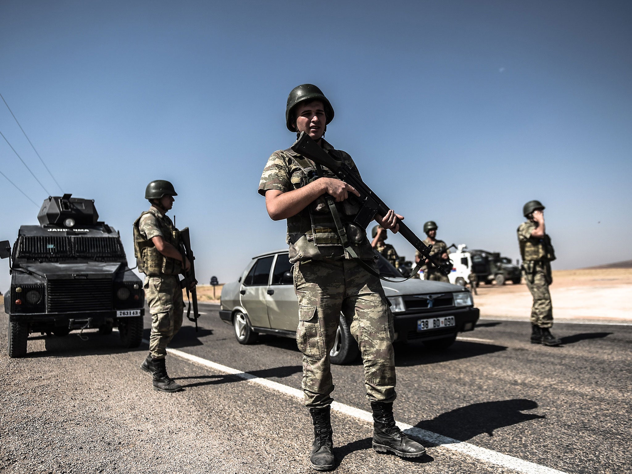 Turkish soldiers standing guard near the Turkey-Syrian border post in Sanliurfa