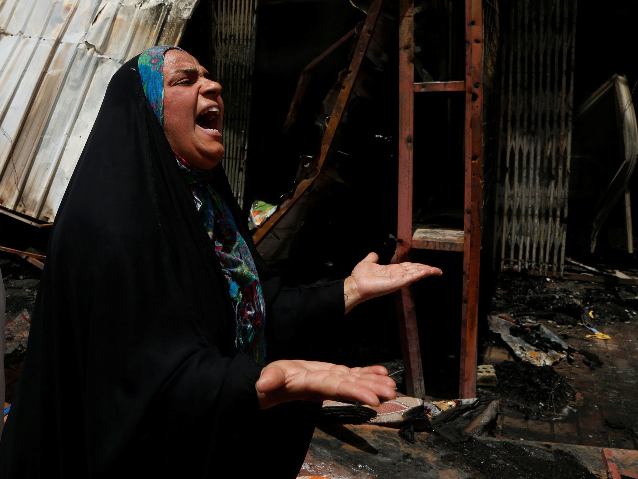 A woman reacts at the scene of a car bomb attack in Baghdad's mainly Shi'ite district of Sadr City, Iraq, May 11, 2016