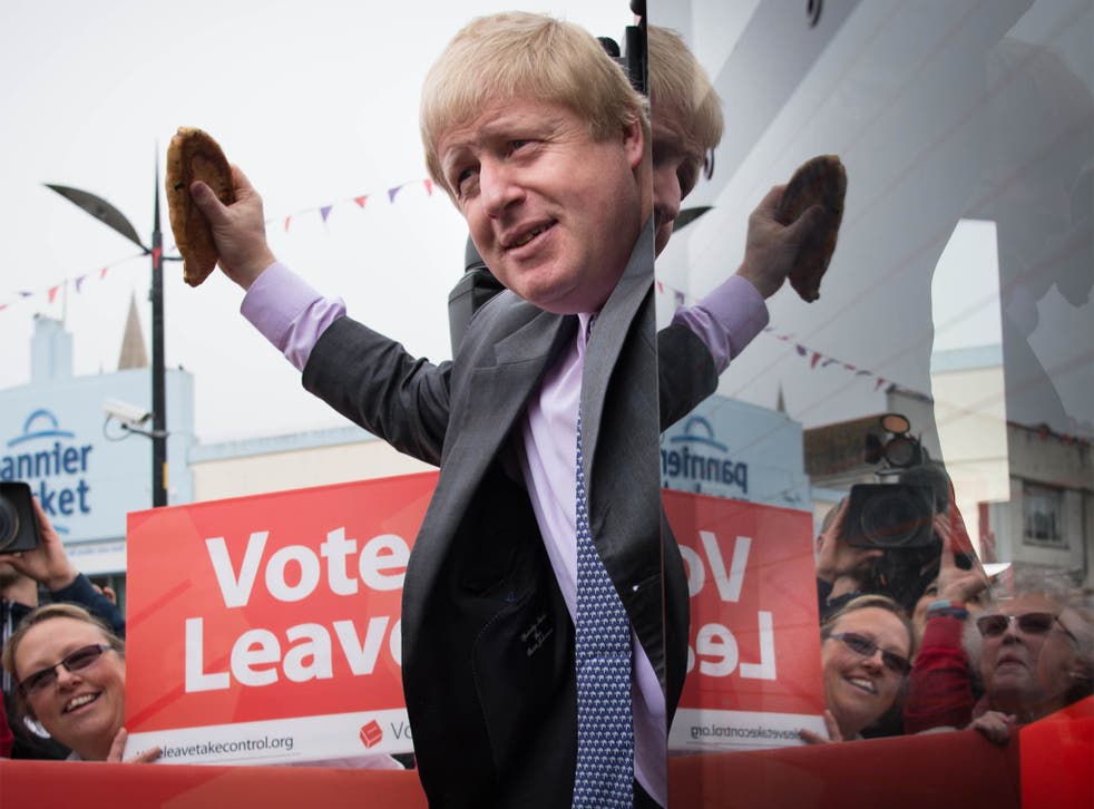 Boris Johnson salutes the crowd with a Cornish pasty as he boards the Vote Leave campaign bus in Truro, Cornwall