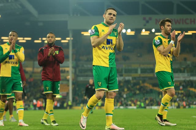 Norwich applaud the home support after the final whistle