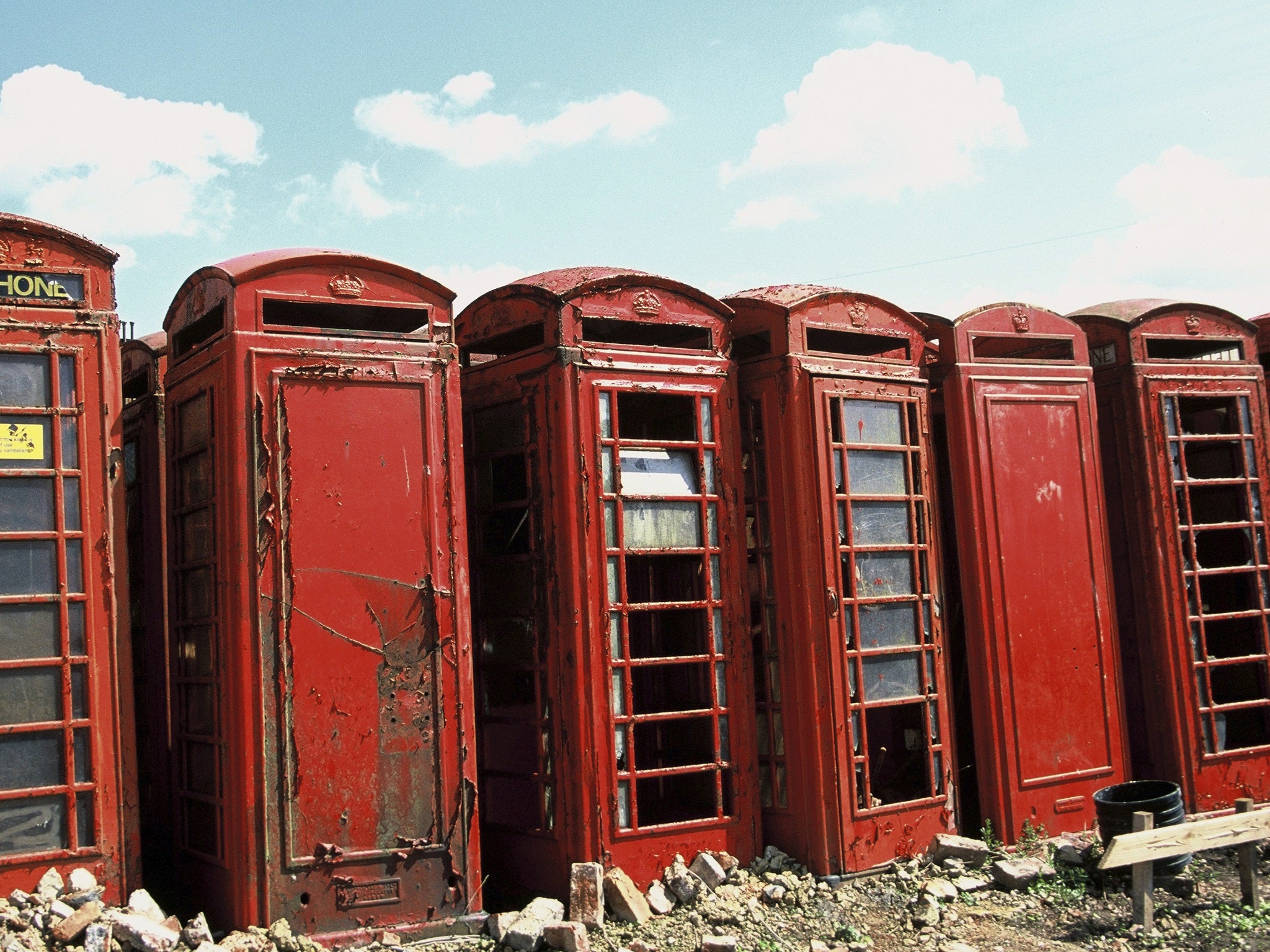 Old phoneboxes abandoned on scrapyard