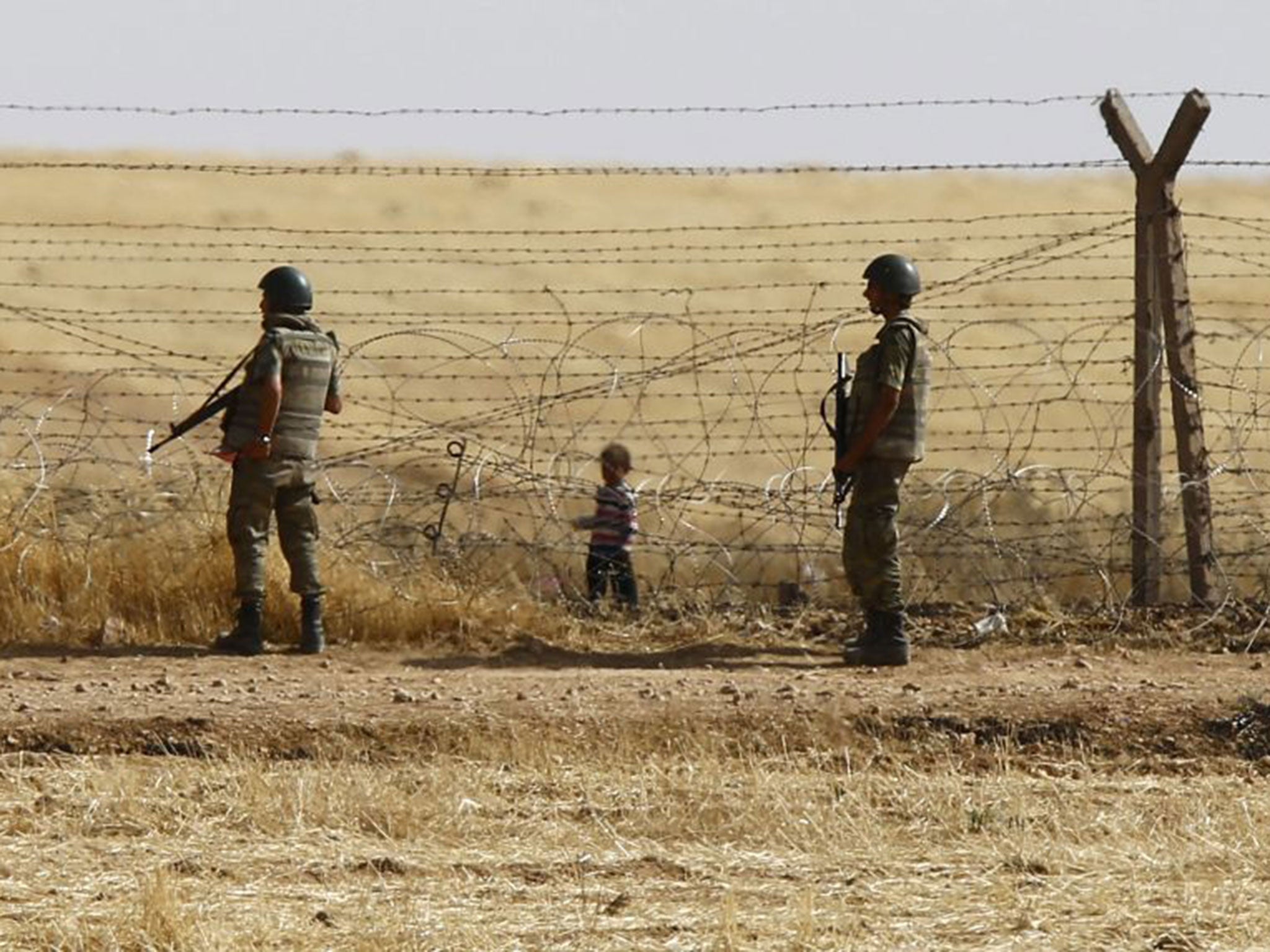 Turkish soldiers stand guard on the border with Syria, near the southeastern town of Akcakale. Turkey is the largest host country, having taken in over 2.7 million Syrian refugees
