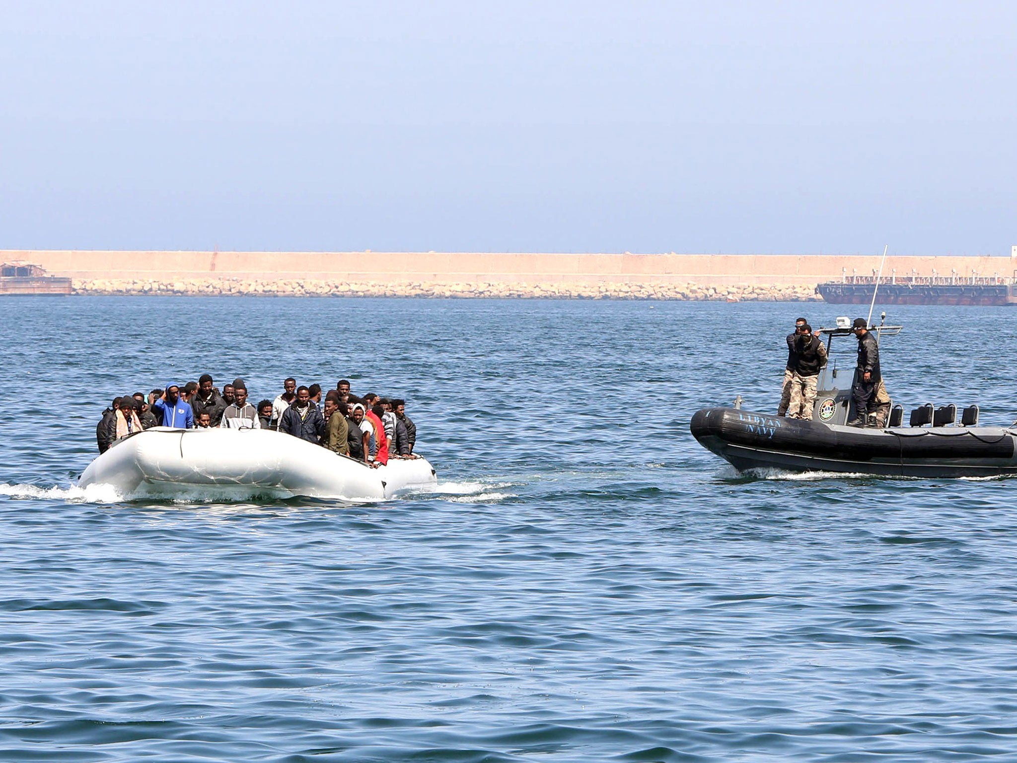 Libyan coast guards chase down a boat of illegal migrants bound for the Italian island of Lampedusa