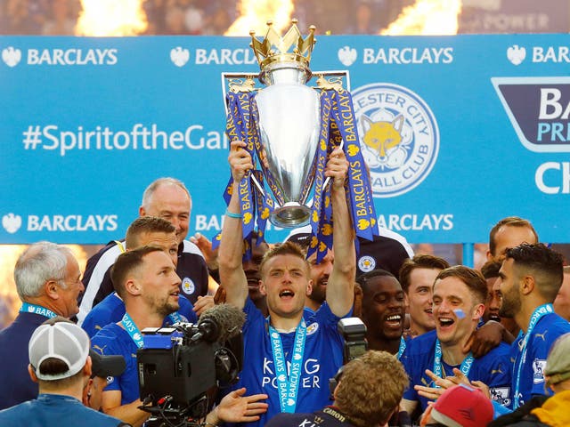 <p>Leicester City's Jamie Vardy lifts the trophy as they celebrate winning the Barclays Premier League</p>