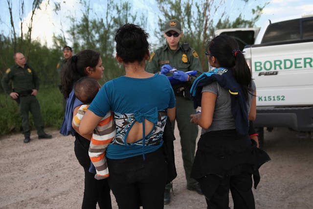 Immigrants from central America turn themselves in to US Border Patrol agents after crossing the Rio Grande River from Mexico