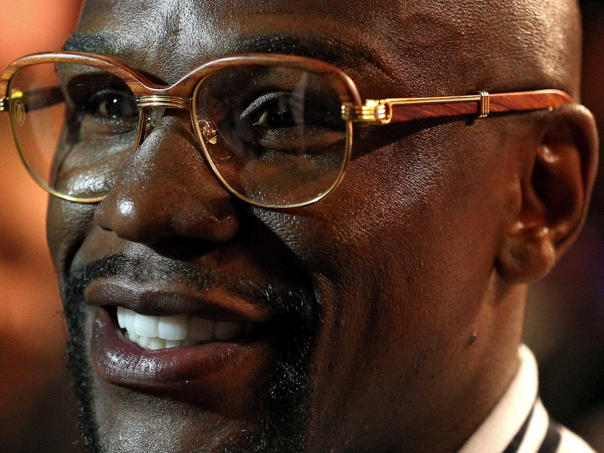 A bespectacled Floyd Mayweather looks on between boxing matches in Washington last month