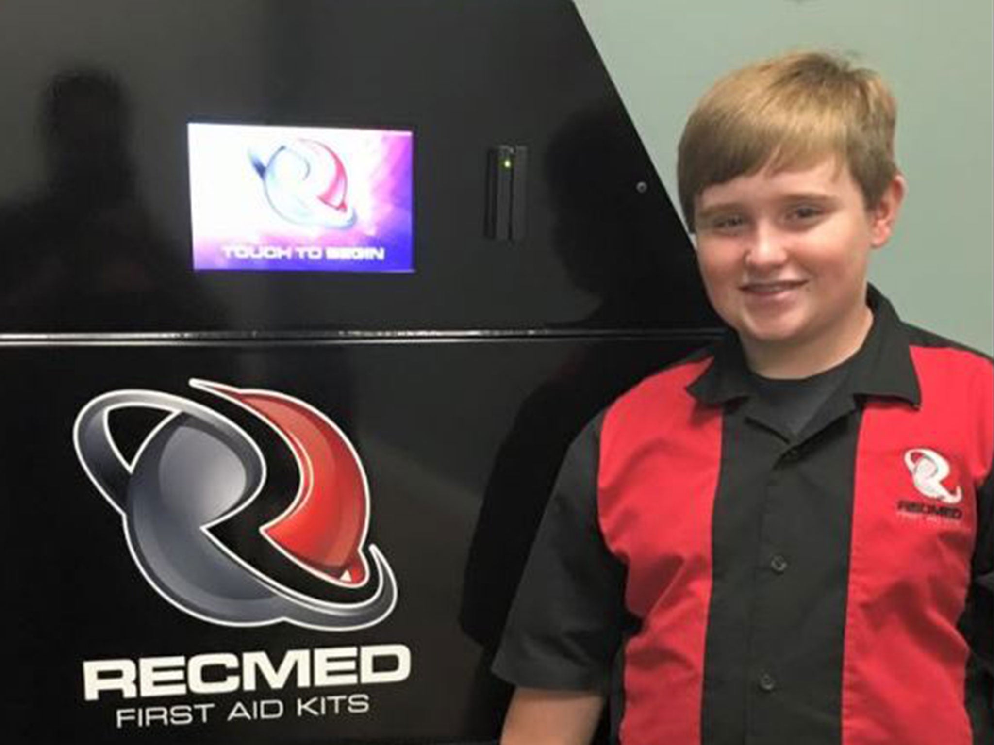 Taylor Rosenthal, 14, demonstrates one of his RecMed first aid vending machines
