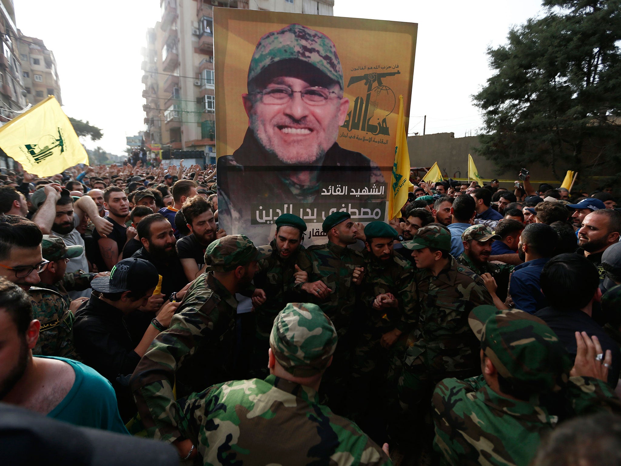 Hezbollah supporters carry a picture of Mustafa Badreddine during his funeral procession