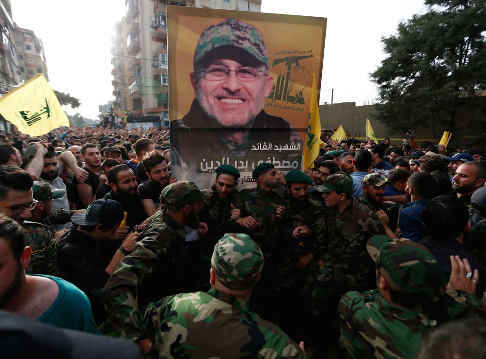 Hezbollah supporters carry the picture of their slain commander Mustafa Badreddine, who was killed in Syria, during his funeral procession in a southern suburb of Beirut, Lebanon