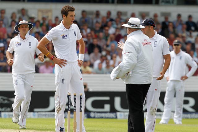 Steven Finn speaks to the umpire after knocking the bails off whilst bowling