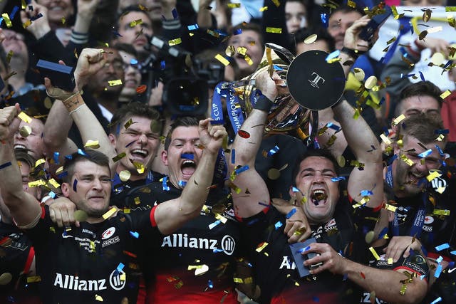 Saracens players left the trophy as they celebrate becoming champions of Europe for the first time