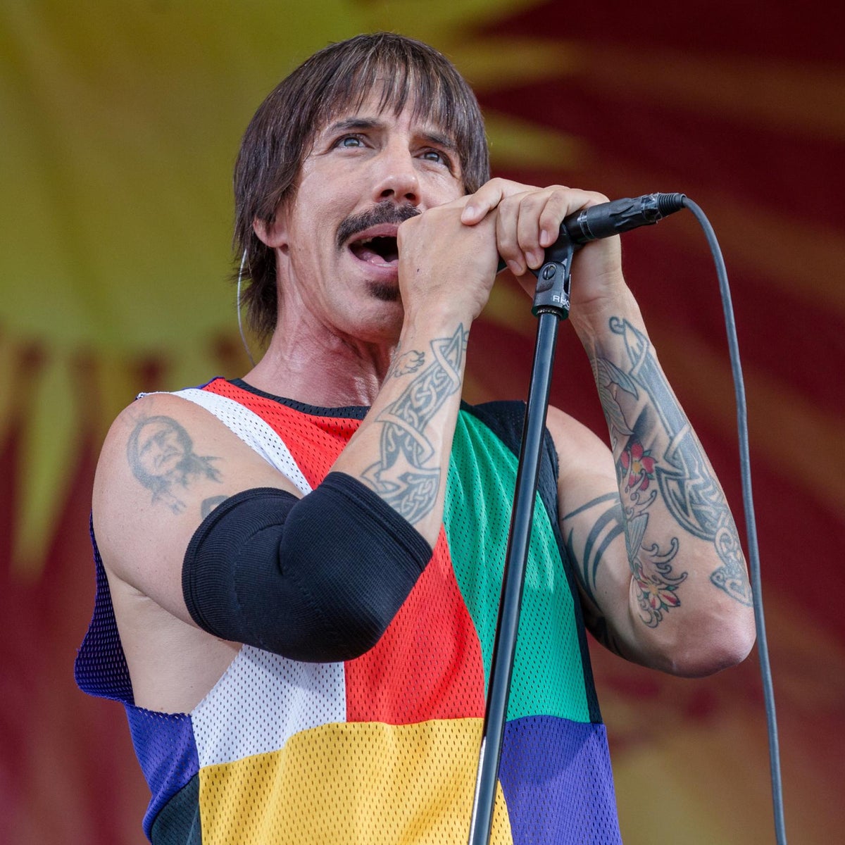 Anthony Kiedis performing on stage with Red Hot Chili Peppers