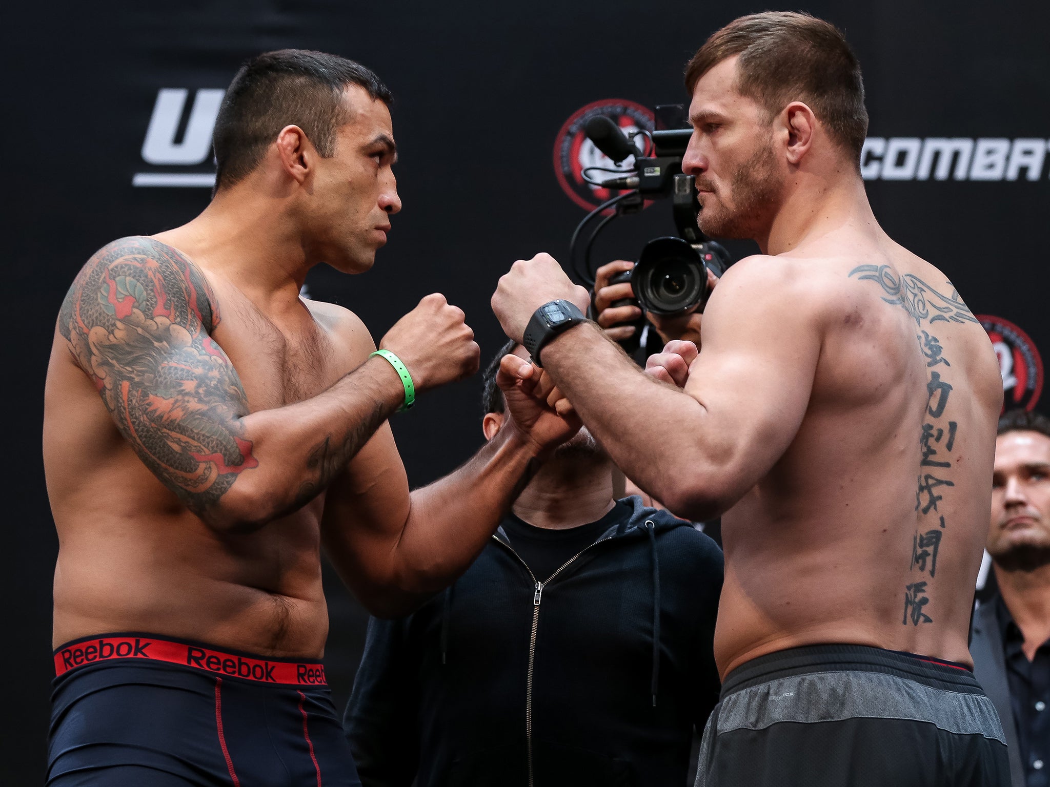 Fabricio Werdum and Stipe Miocic face off during the UFC 198 weigh-in