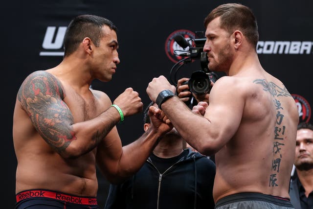 Fabricio Werdum and Stipe Miocic face off during the UFC 198 weigh-in
