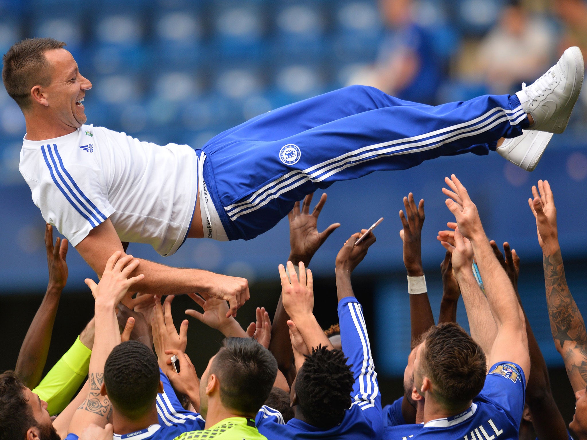 John Terry is given the bumps by his team-mates at Stamford Bridge on Sunday
