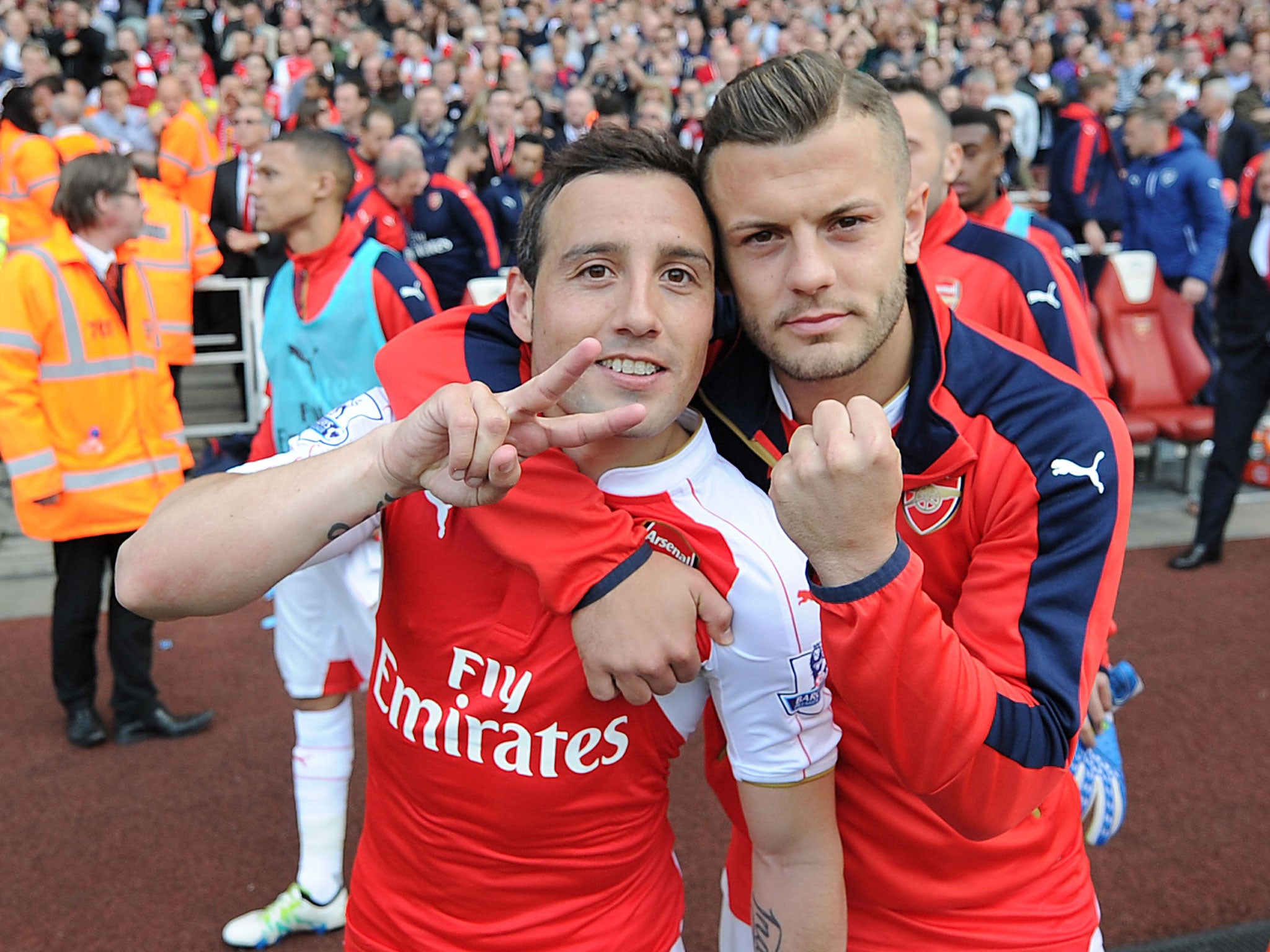 Jack Wilshere celebrates with Santi Cazorla after Arsenal finish above Tottenham in the league