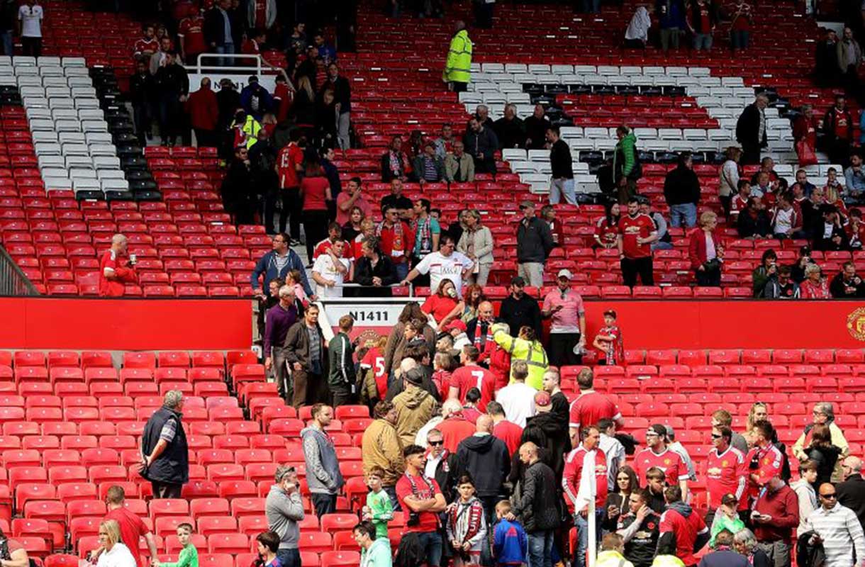 Spectators evacuate Old Trafford after the bomb alert on Sunday