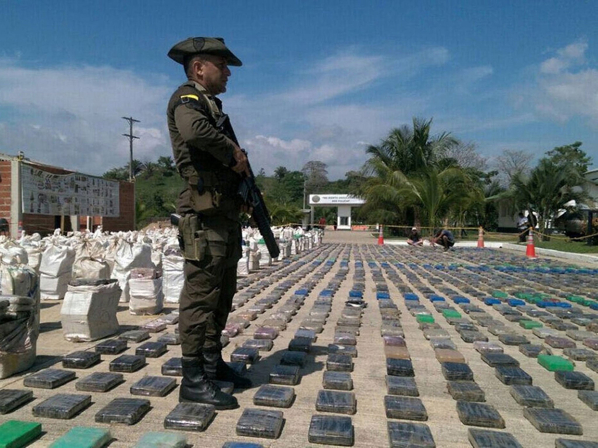 A Colombian police officer stands guard over a confiscated cocaine haul; Mr Ortega says he was an innocent victim of the war on drugs