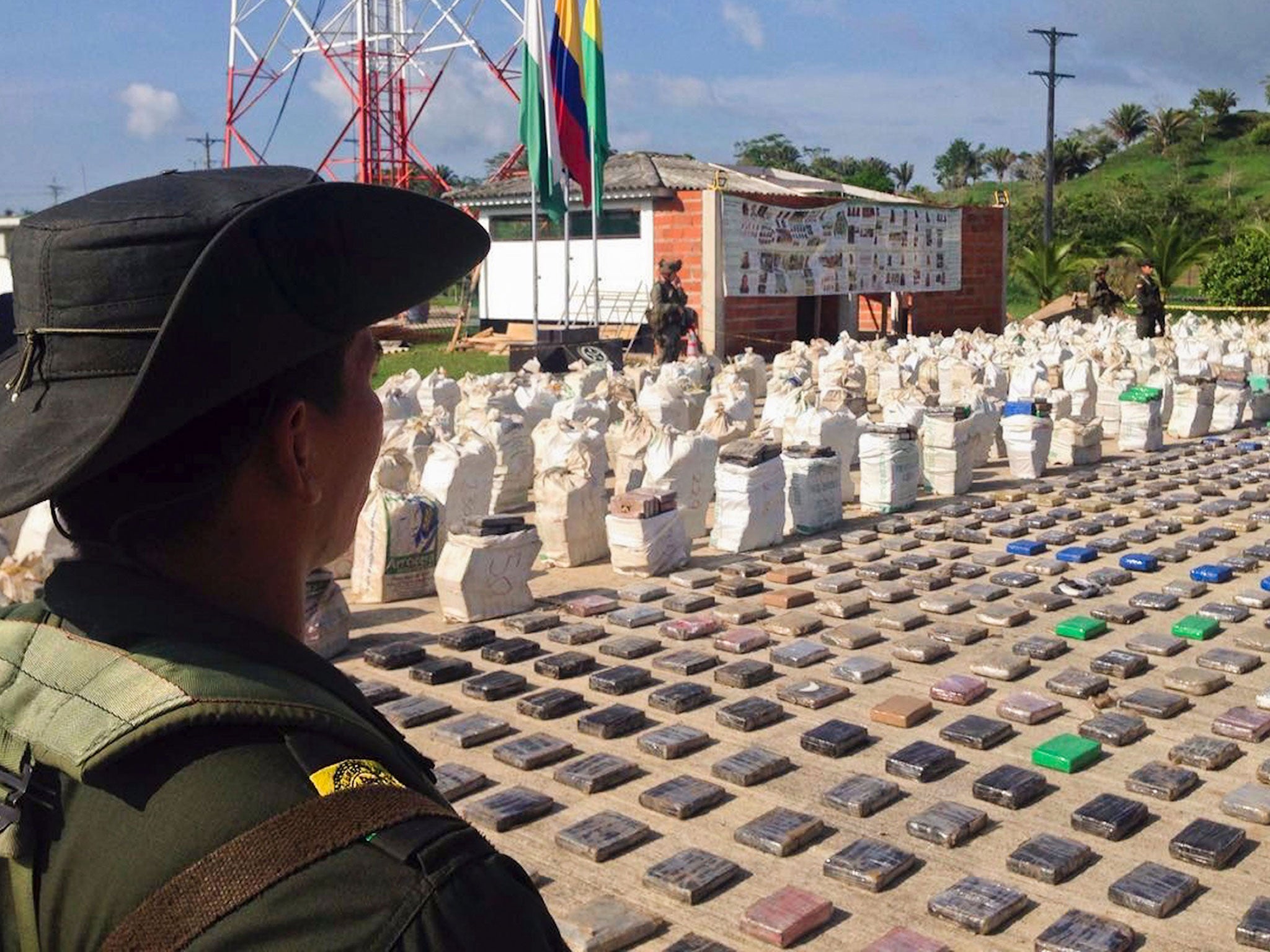 A Colombian police officer standing guard over eight tons of seized cocaine in Turbo