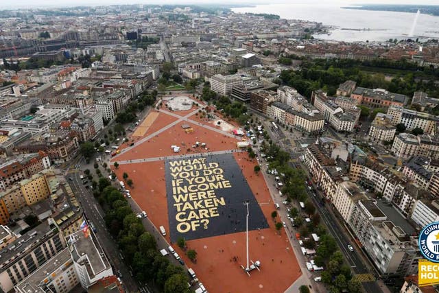 Activists in Switzerland set a Guinness world record for the largest campaign poser as the country prepares to vote on proposals to introduce a universal basic income