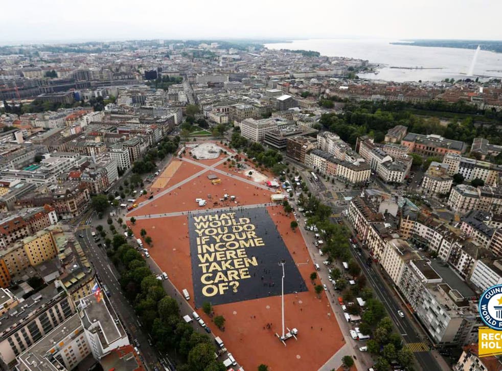 Activists in Switzerland set a Guinness world record for the largest campaign poser as the country prepares to vote on proposals to introduce a universal basic income