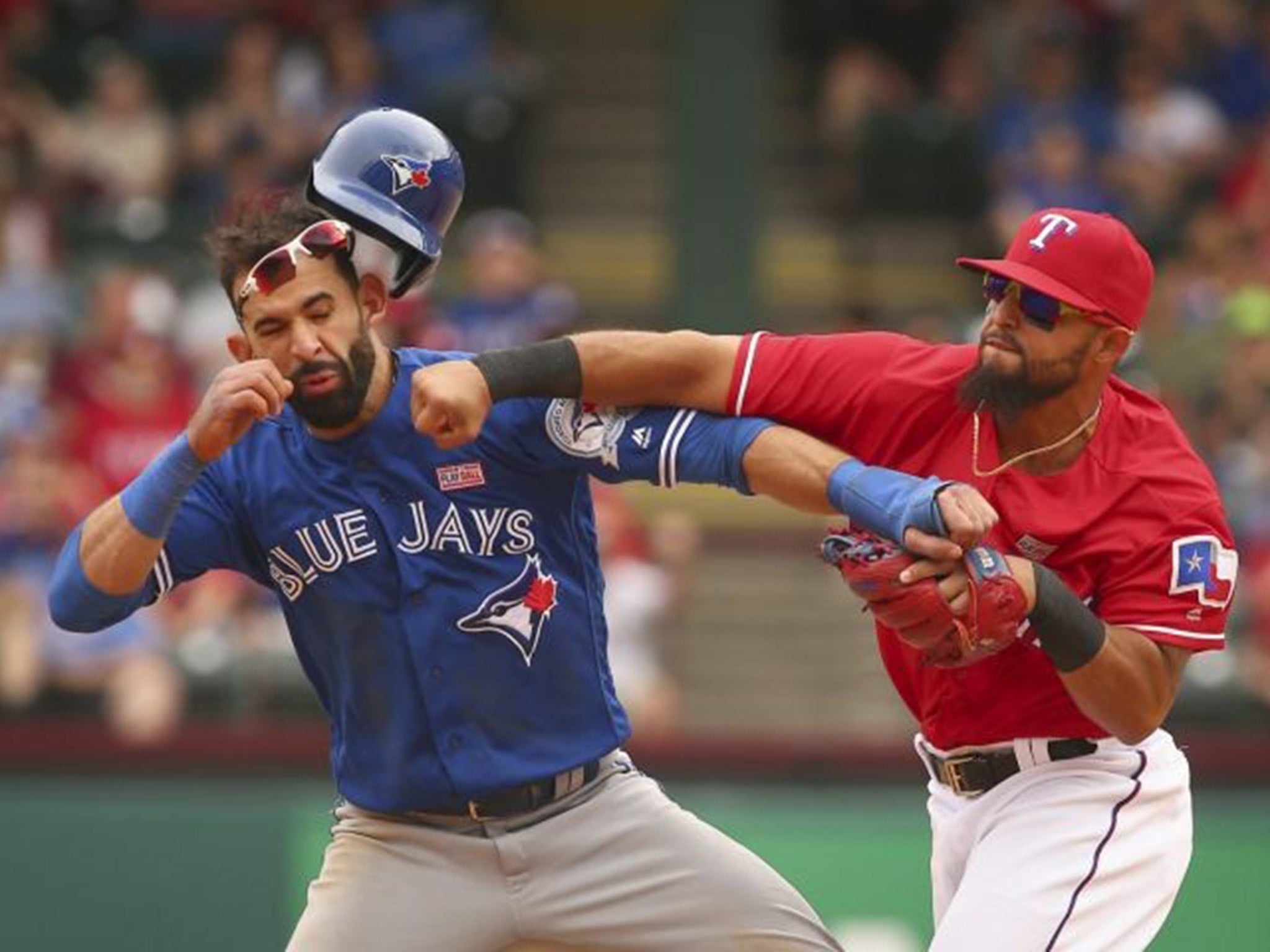 Rougned Odor (right) lands a right hook to the jaw of Jose Bautista (left)