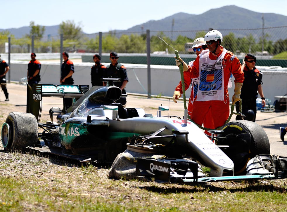 Lewis Hamilton's stricken Mercedes awaits recovery after his crash with Nico Rosberg in Barcelona
