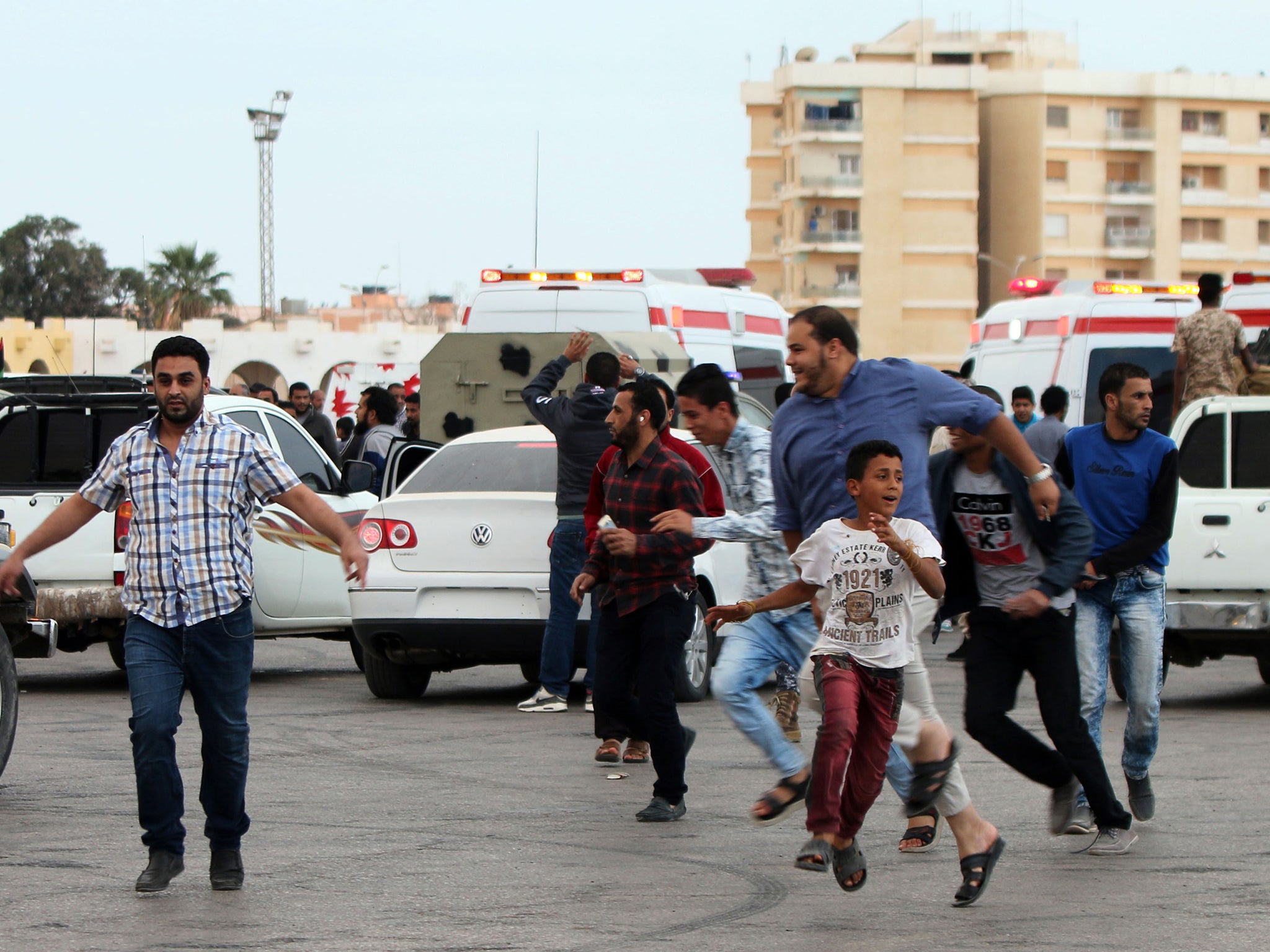 Libyans fleeing shelling at protest in Benghazi. Protesters were calling for Libyan forces to recapture the southern city of Sirte