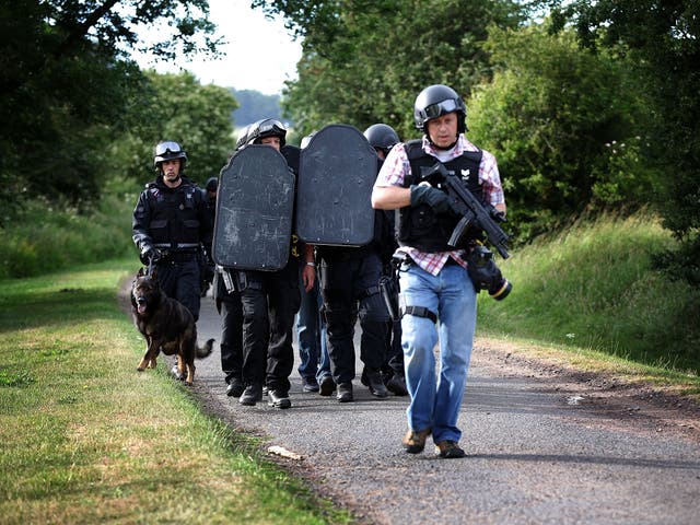 File: Armed police pictured during the search for armed fugitive Raoul Moat near Wagtail Farm in the village of Rothbury, England