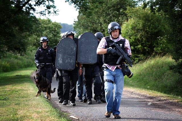 File: Armed police pictured during the search for armed fugitive Raoul Moat near Wagtail Farm in the village of Rothbury, England