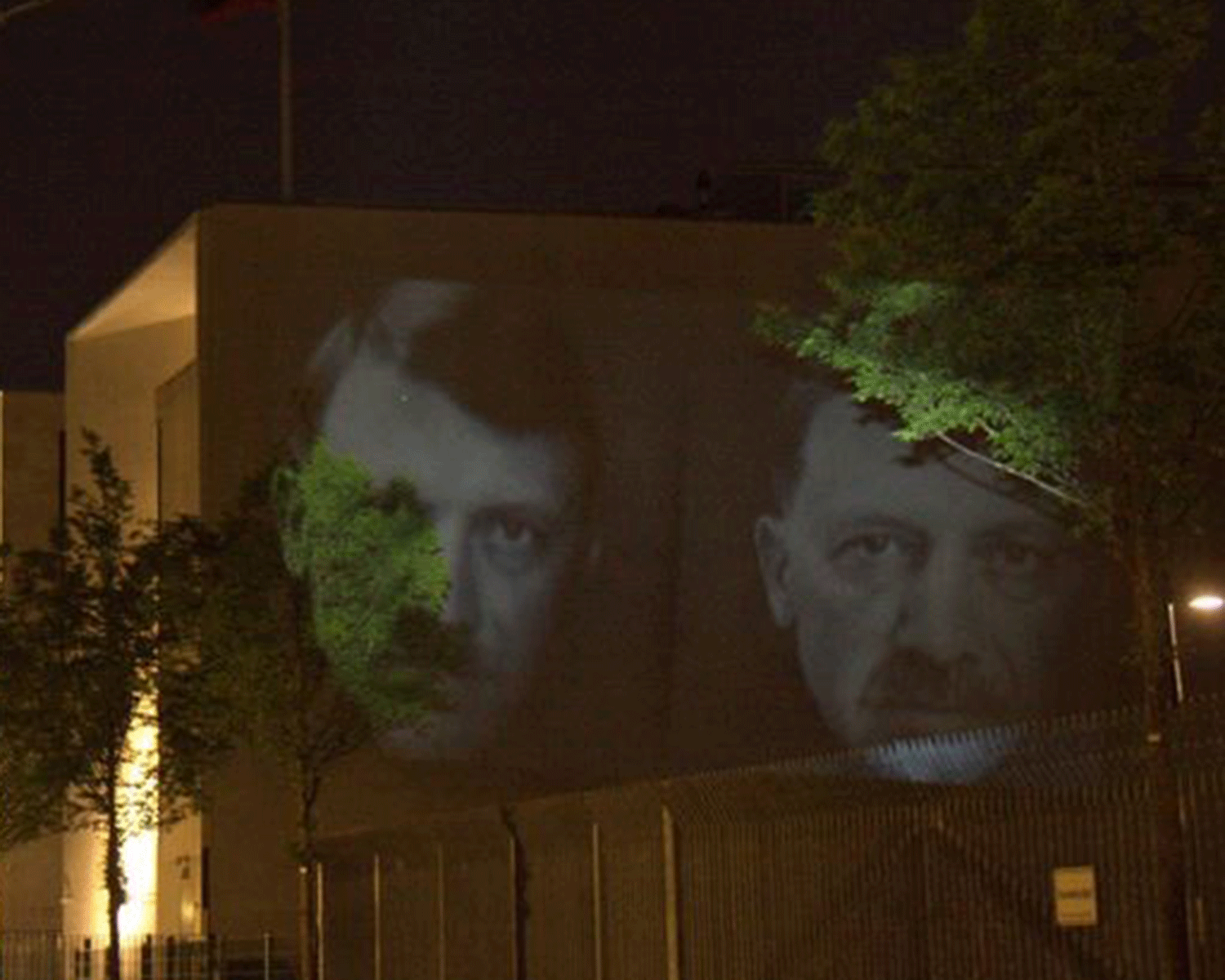Turkish president Erdogan's face is projected alongside Nazi leader Adolf Hitler in Berlin