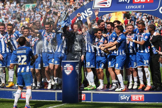 Wigan celebrate lifting the League One title at the DW Stadium