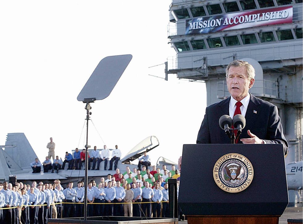 George W Bush  aboard the aircraft carrier USS Abraham Lincoln during a speech in which he declared that major combat in Iraq was finished