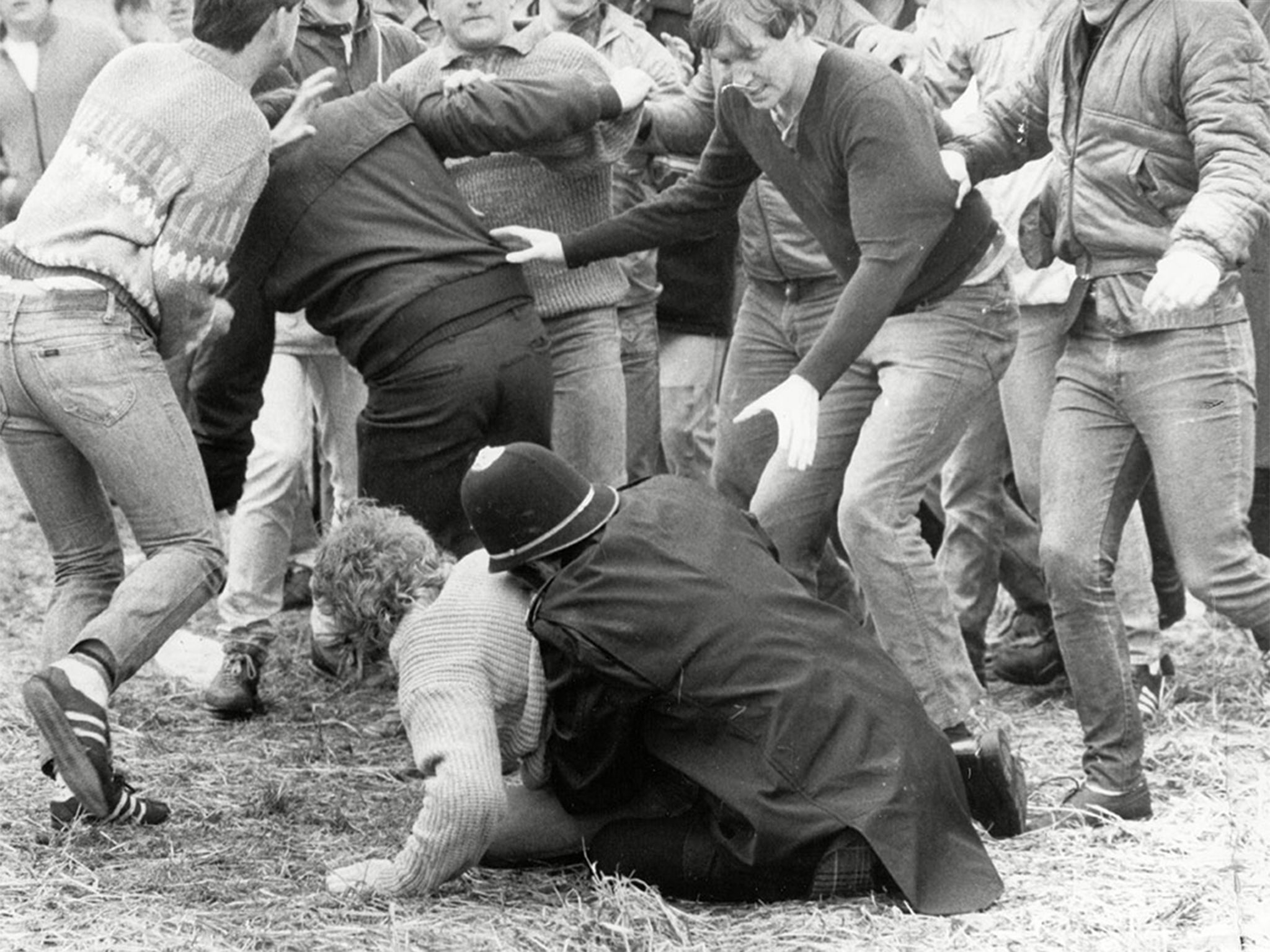 A police officer wrestles a miner to the ground during the 'Battle of Orgreave'