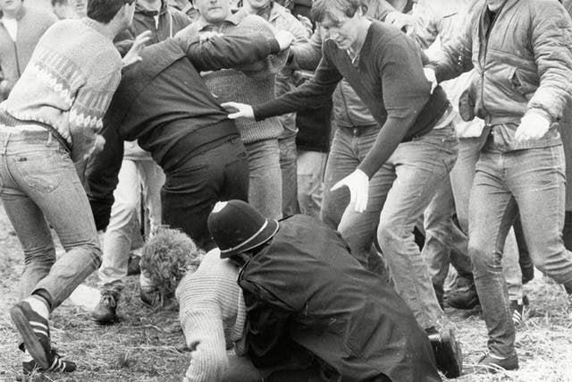 A police officer wrestles a miner to the ground during the 'Battle of Orgreave'