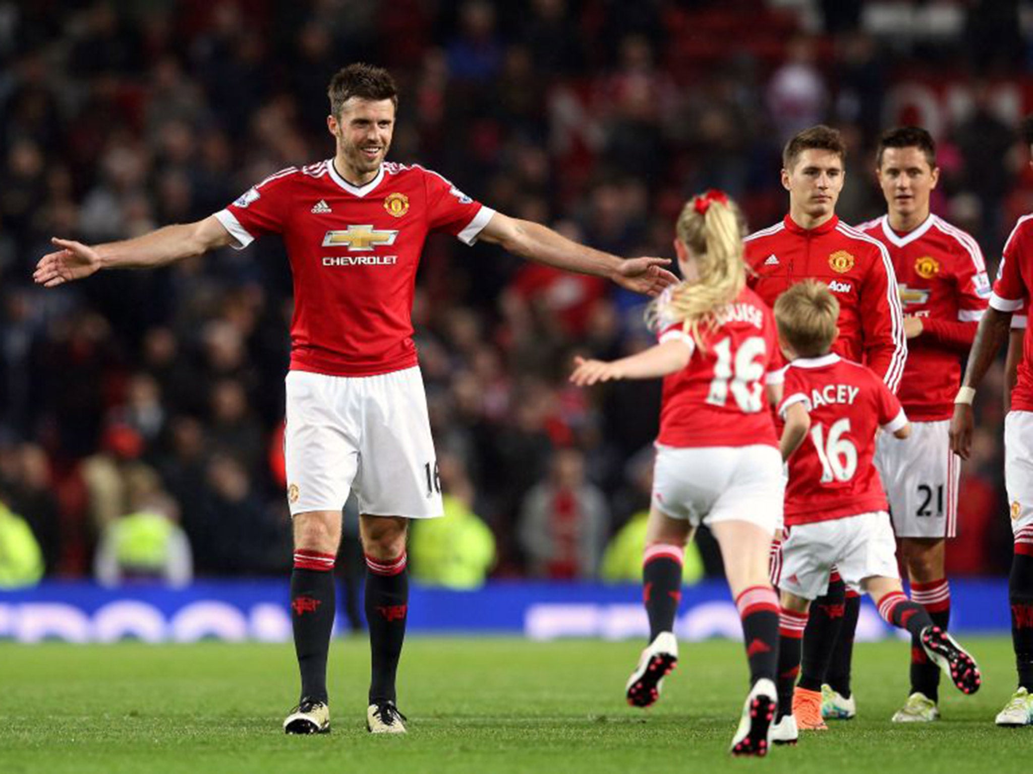 Carrick's children run onto the Old Trafford pitch to join him for the lap of honour