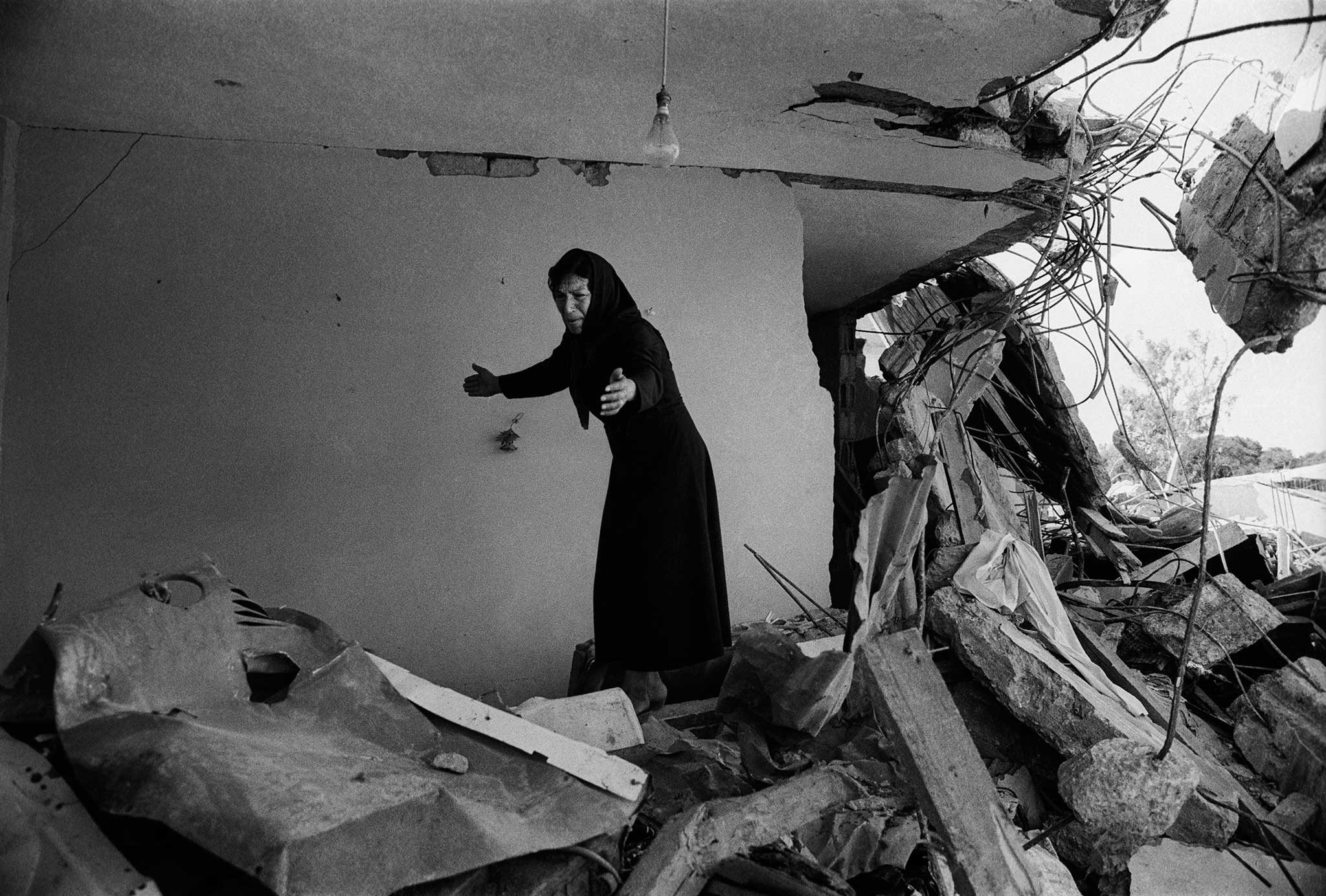 Don McCullin’s image of a Palestinian woman returning to the ruins of her house in Sabra, Beirut, in 1982