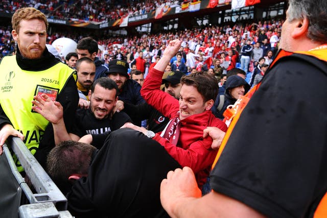  Fans scuffle prior to the UEFA Europa League Final match between Liverpool and Sevilla at St. Jakob-Park