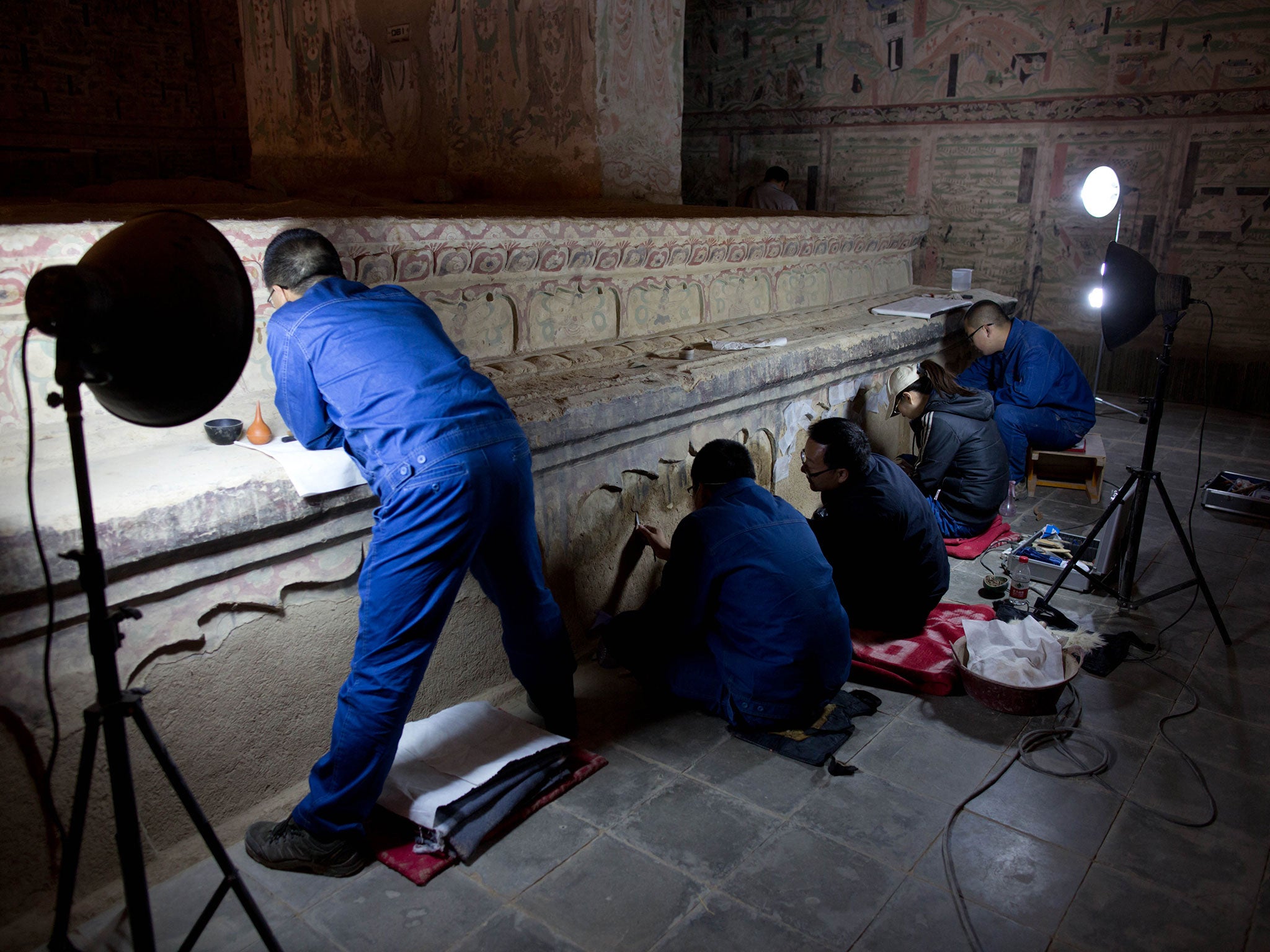 Technicians restore Buddhist art in the Mogao Grottoes