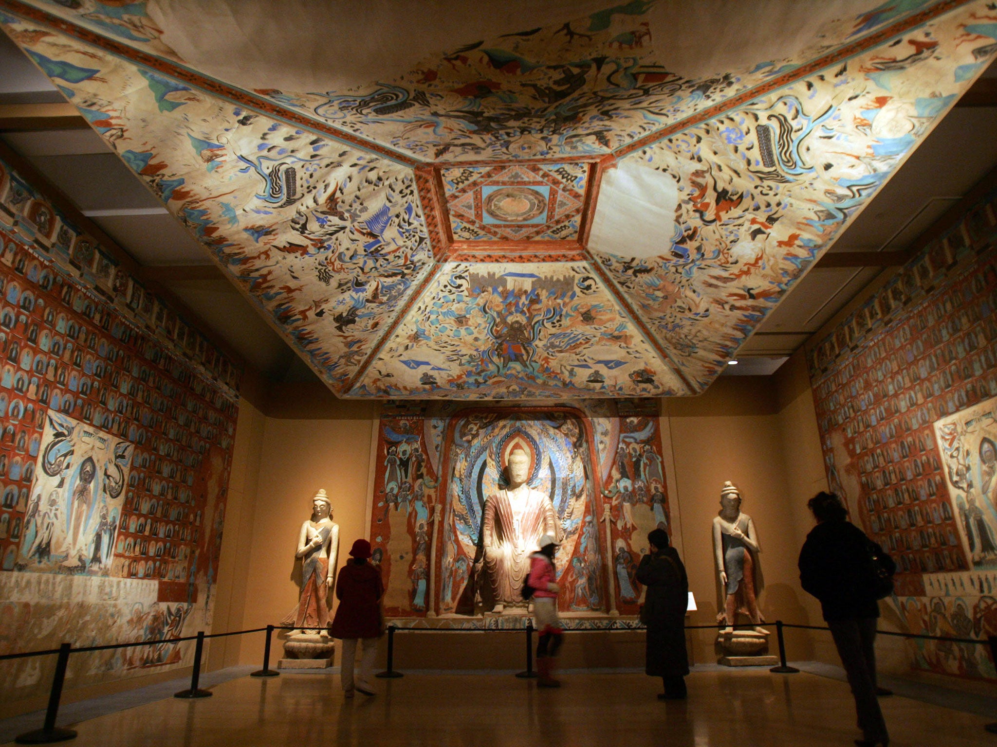 Visitors view replicas of artwork form the Mogao Grottoes at the Dunhuang Art Exhibition