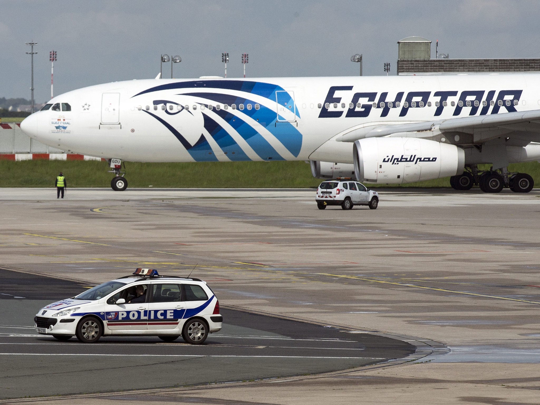 A French police car passes by an Egyptair plane taking off from the Charles de Gaule airport near Paris, France, 19 May 2016