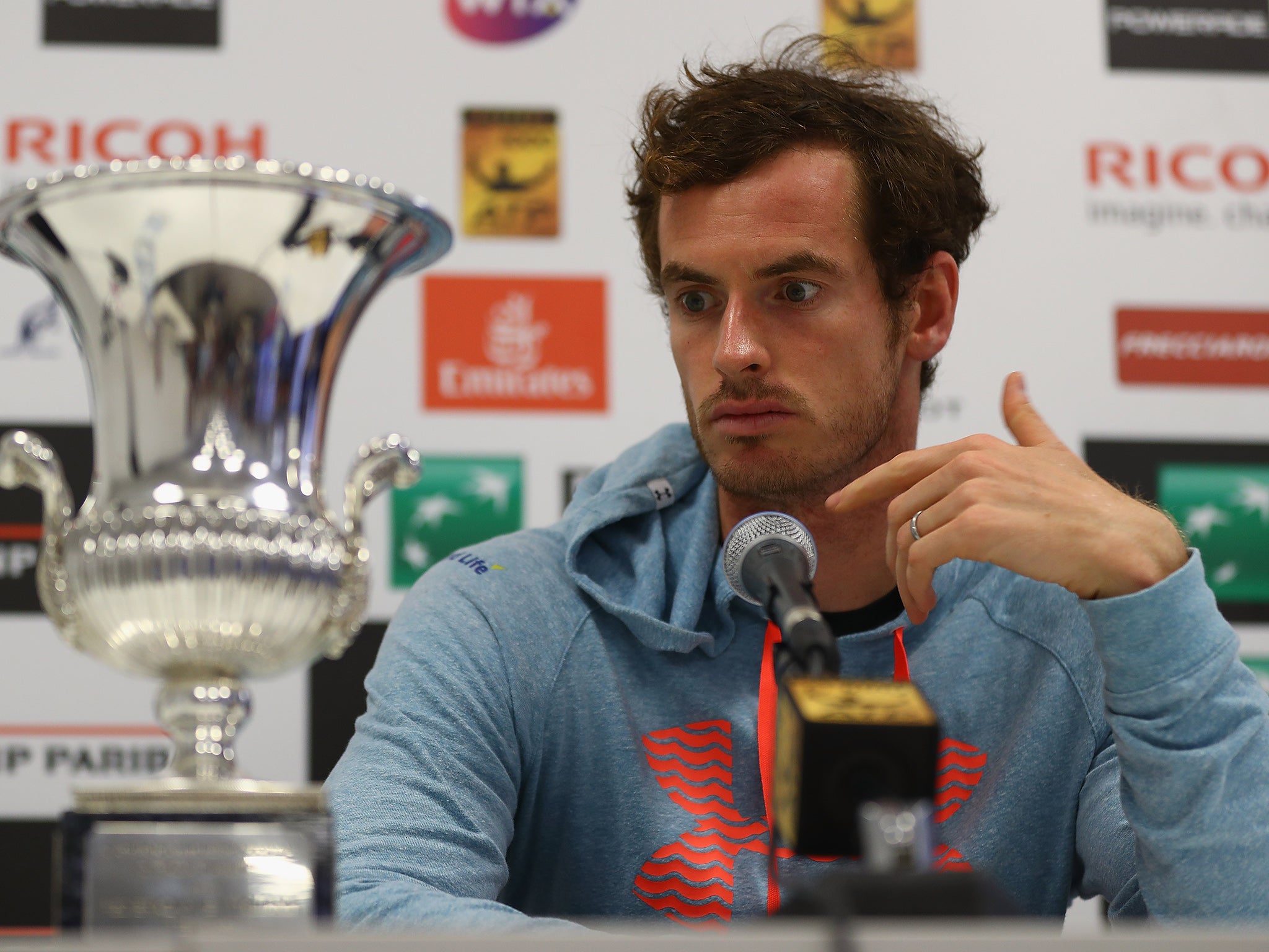 Andy Murray looks at the Rome Masters trophy he won last week