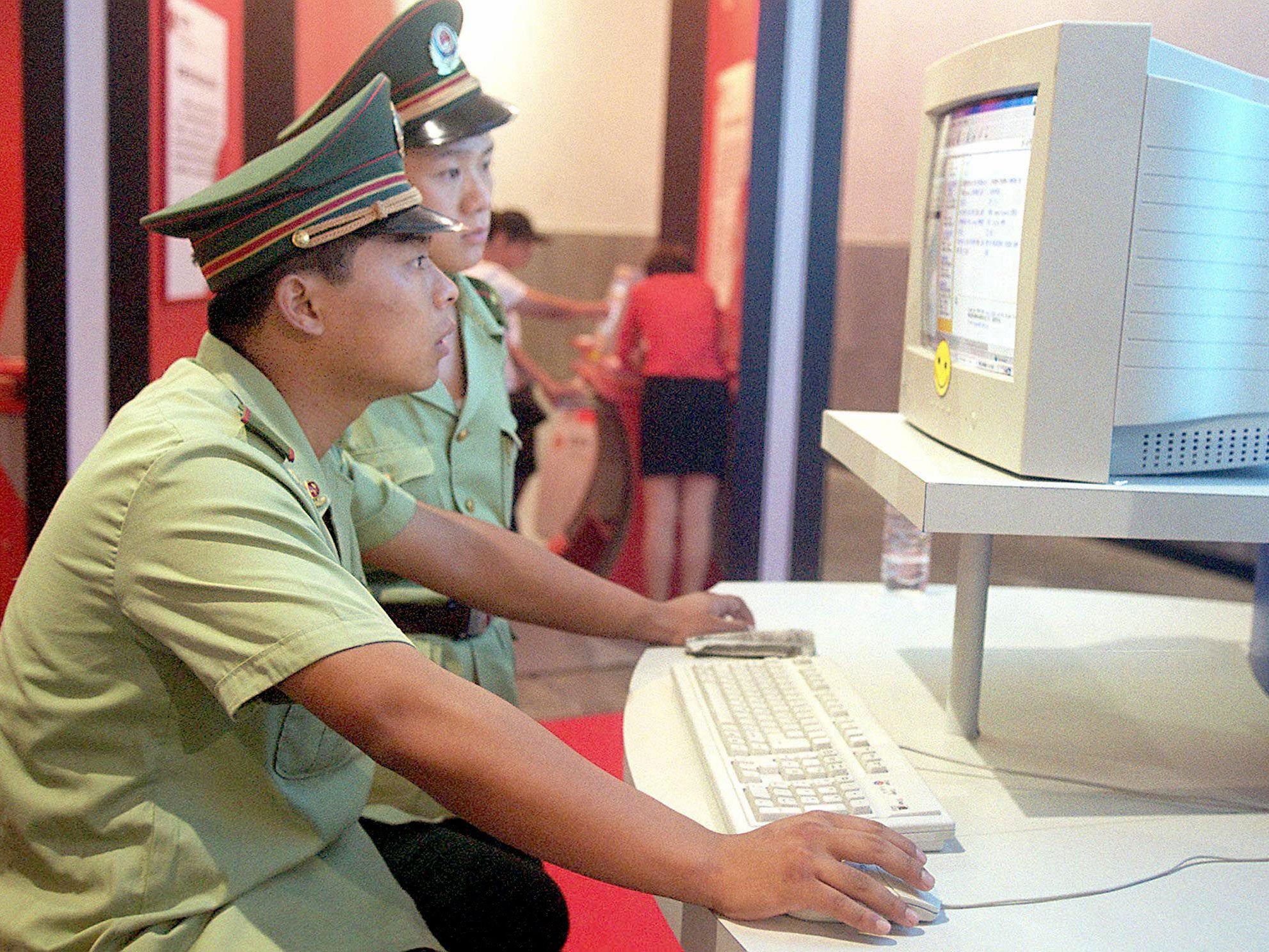 Chinese police officers surf the internet in Beijing in 2000