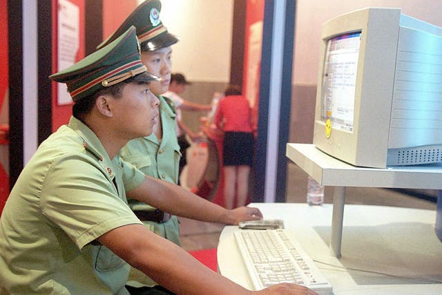 Chinese police officers surf the internet in Beijing in 2000