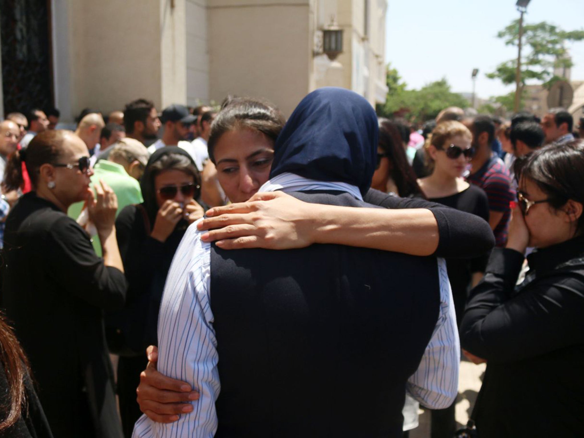 Relatives and friends of those who died on the EgyptAir A320 comfort each other yesterday during prayers at Abou Bakr el-Sedek mosque in Cairo