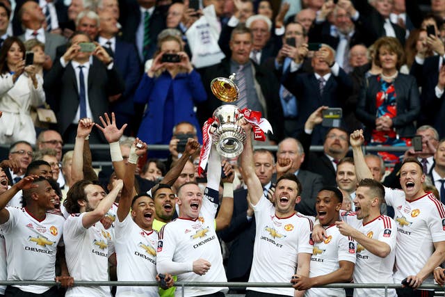 Wayne Rooney and Michael Carrick lift the FA Cup after Manchester United beat Crystal Palace