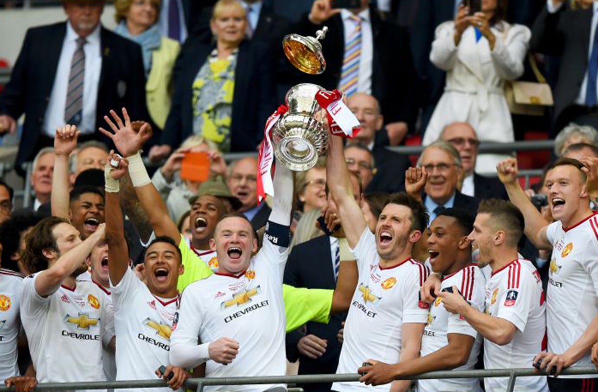 Wayne Rooney and Michael Carrick lift the FA Cup trophy at Wembley